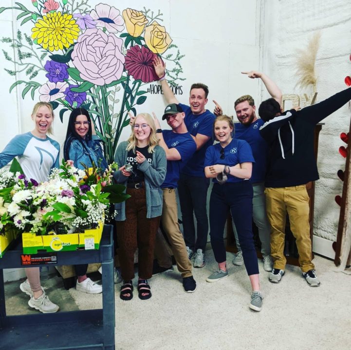 AdShark team volunteering at Hope Blooms to make floral bouquets