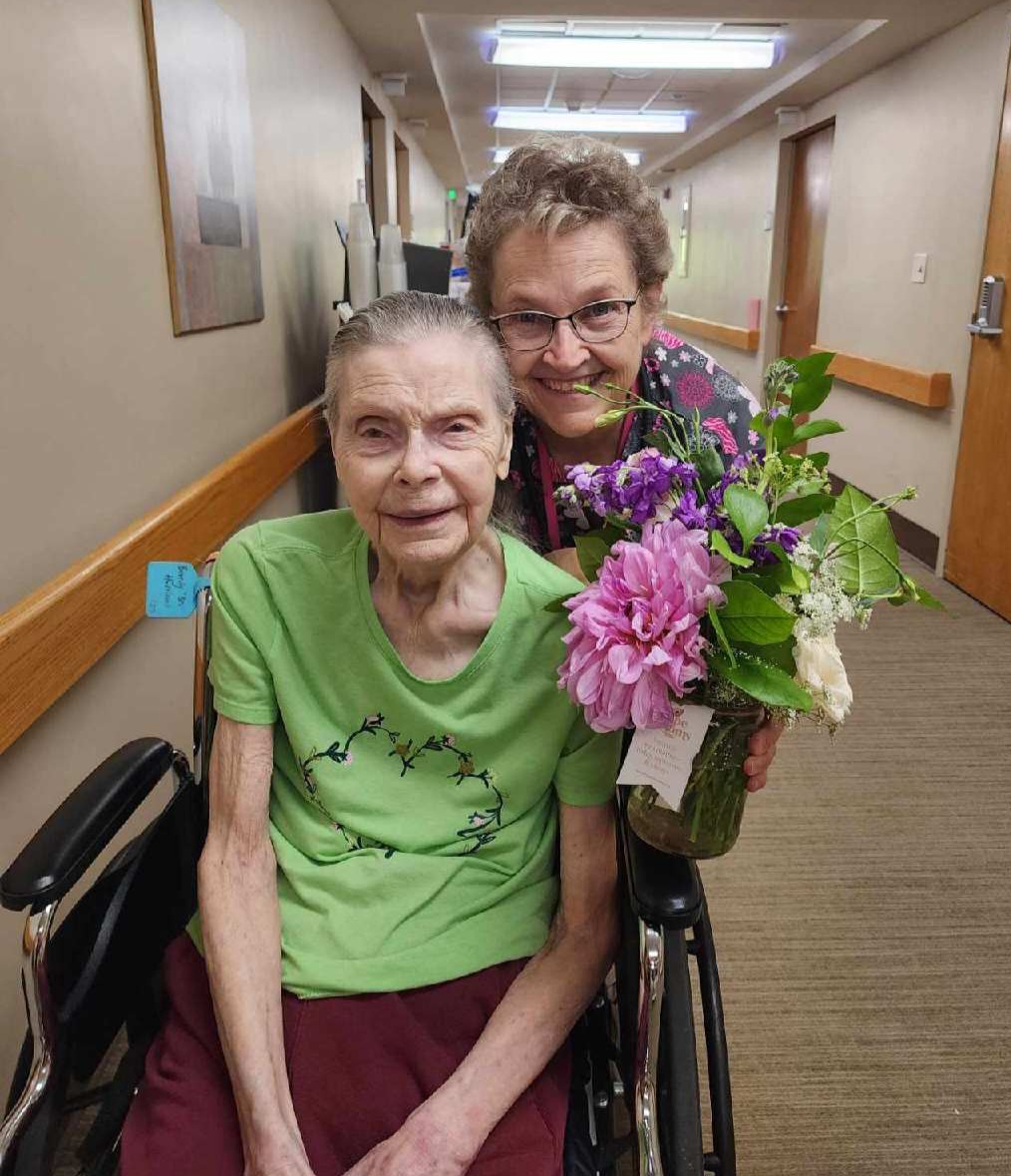 A Petal It Forward recipient receiving garden blooms. 