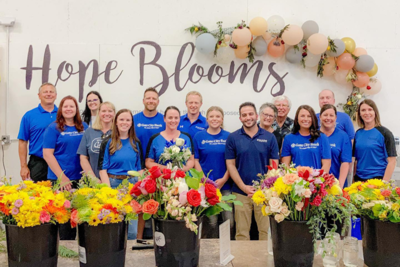 Gate City Bank employees volunteer to assemble floral bouquets for Hope Blooms